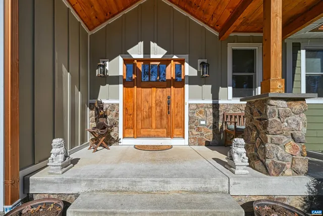 a view of a hallway with wooden floor and closet