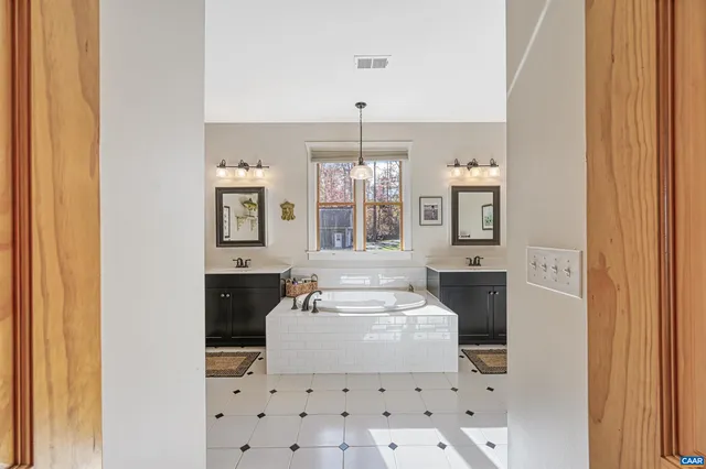 a bedroom with a bed and ceiling fan