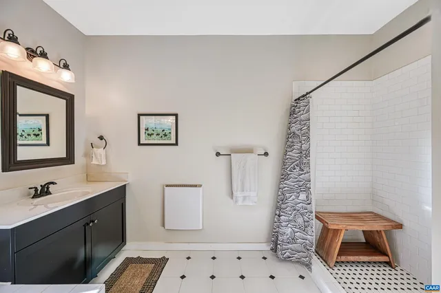a bathroom with double sink and two mirror
