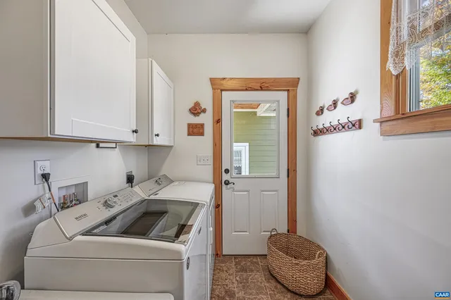 a view of a lake in middle of a town with trees