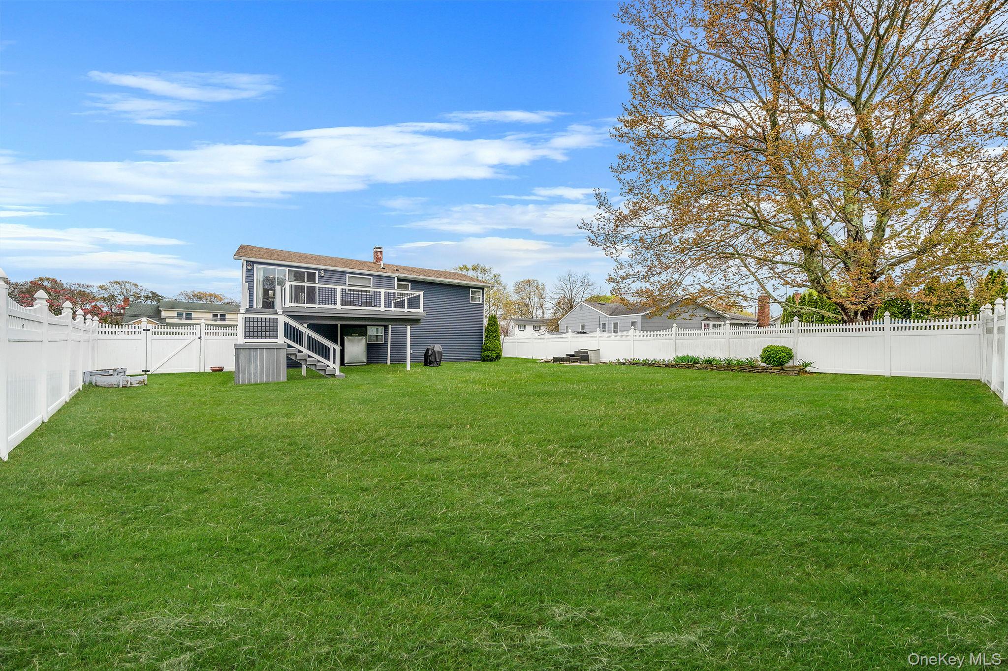 110 Stephen Road Bayport, NY 11705 - Photo 8 of 39 a view of a house with a big yard and large trees