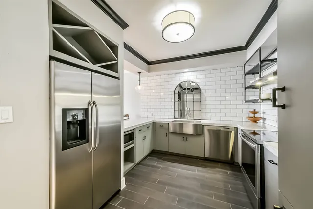 a kitchen with cabinets and stainless steel appliances
