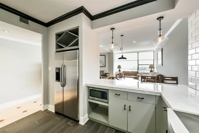 a kitchen with kitchen island a counter top space a sink stainless steel appliances and cabinets