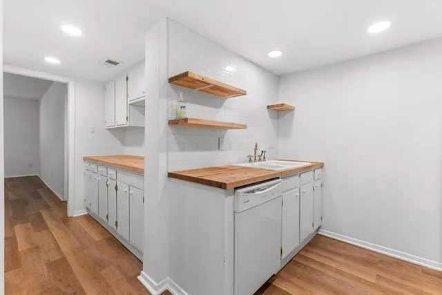 a kitchen view with wooden floor washer and dryer