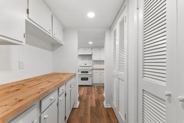 a view of washer and dryer with kitchen in the background