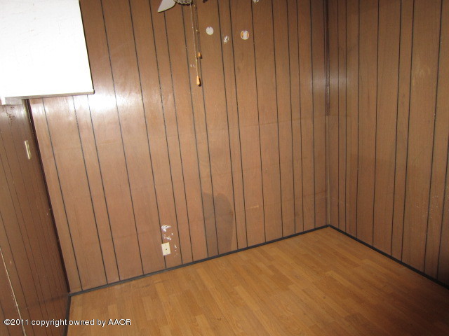 4501 South Bonham Street Amarillo, TX 79110 - Photo 7 of 13 a view of an empty room with wooden walls