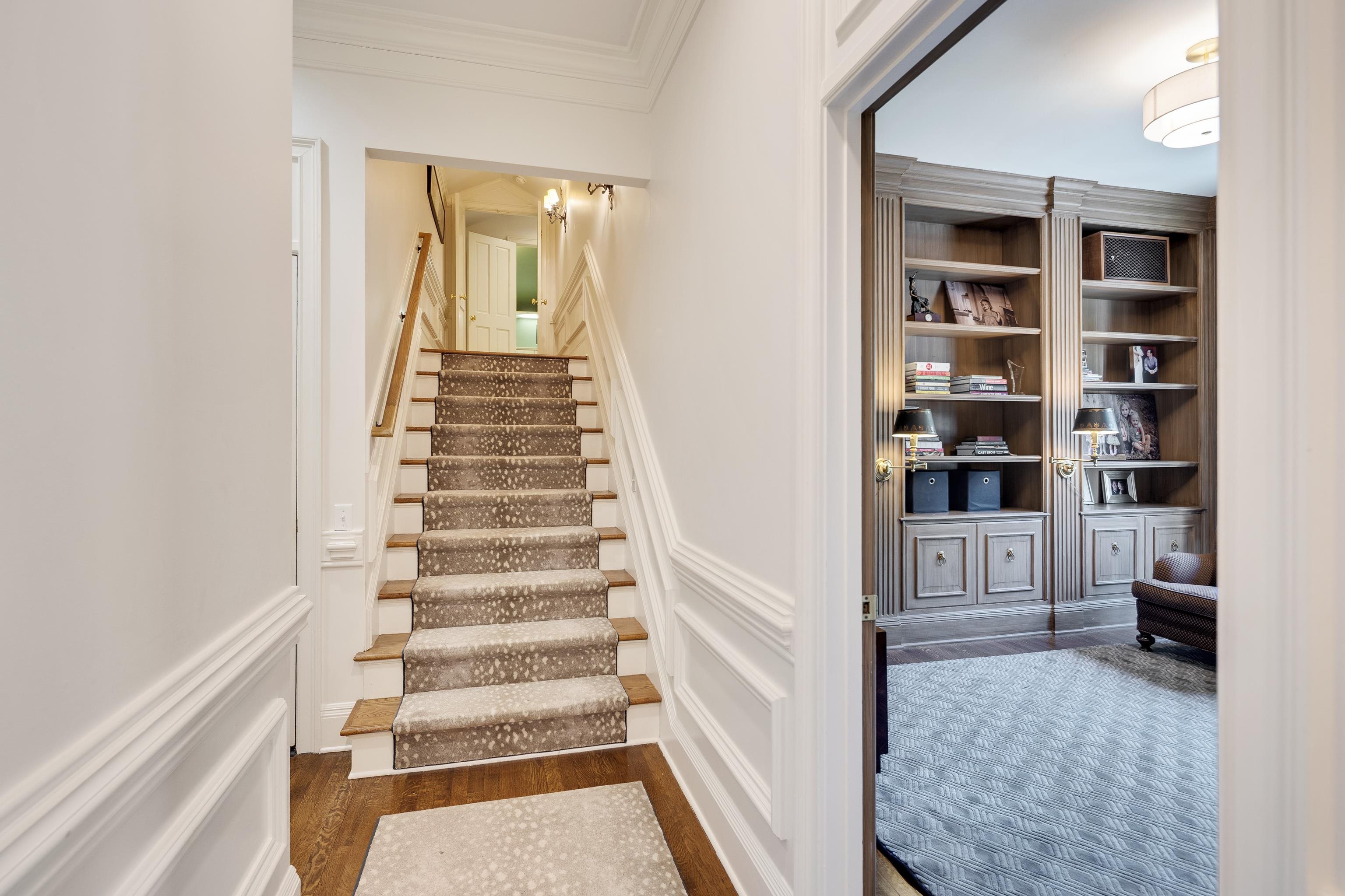 165 Waring Road Memphis, TN 38117 - Photo 21 of 40 Staircase with crown molding, wood finished floors, and built in shelves