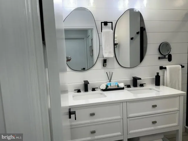 a bathroom with a double vanity sink and a mirror