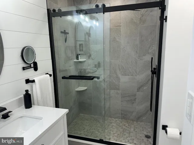 a bathroom with a shower and a sink
