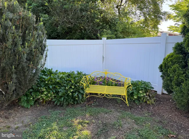 a view of a bench in a backyard