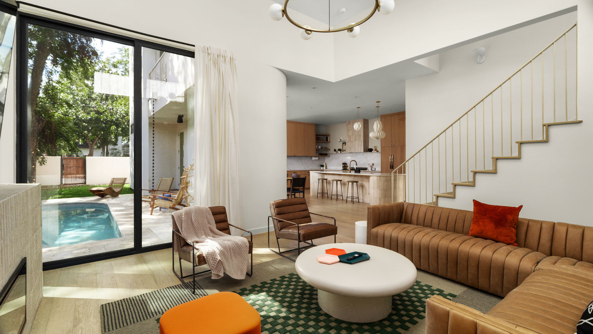Undisclosed Address Austin, TX 78702 - Photo 11 of 38 Living room featuring suspended lighting, light wood-type flooring, and a high ceiling