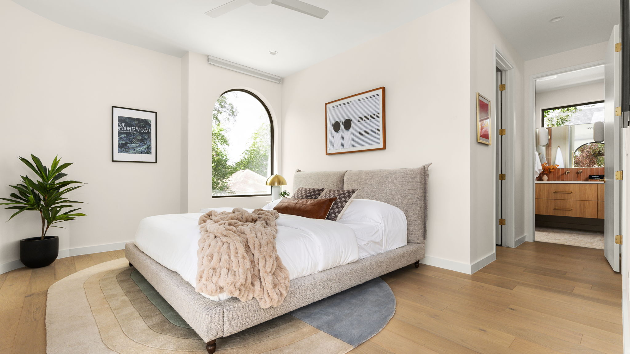 Undisclosed Address Austin, TX 78702 - Photo 21 of 38 Bedroom with light wood-type flooring, a ceiling fan, and connected bathroom