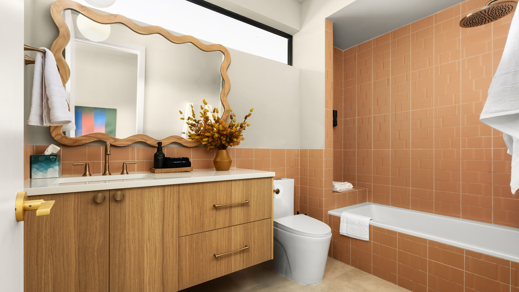 Undisclosed Address Austin, TX 78702 - Photo 31 of 38 Full bathroom with tile walls, vanity, tiled shower / bath combo, light tile patterned floors, and wainscoting