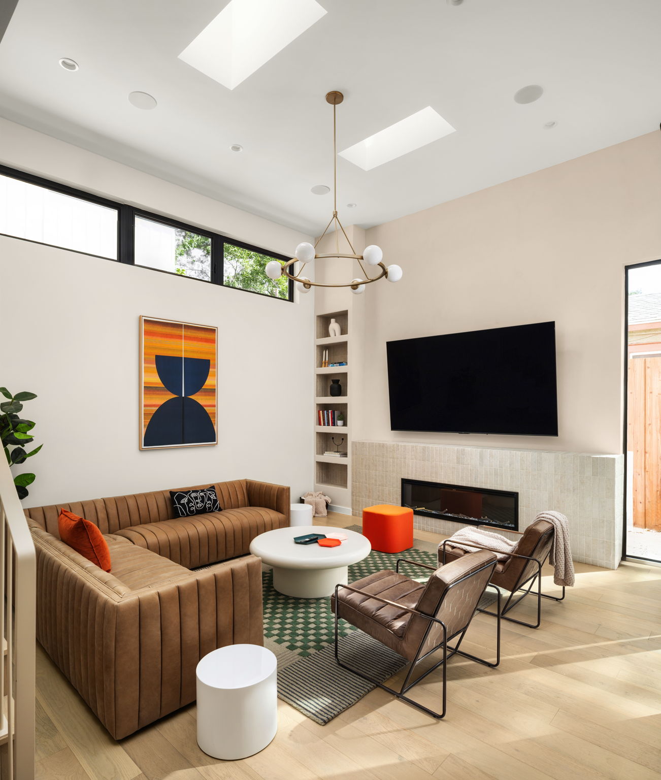 Undisclosed Address Austin, TX 78702 - Photo 10 of 38 Living area featuring wood finished floors, a glass covered fireplace, and a skylight