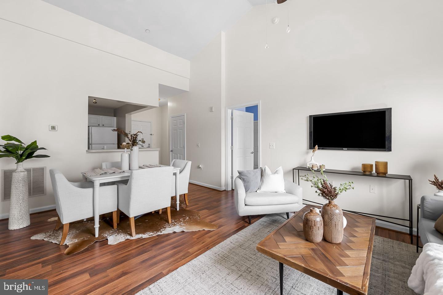 23 Pierside Drive, Unit 413 Baltimore, MD 21230 - Photo 12 of 36 a living room with furniture and a flat screen tv