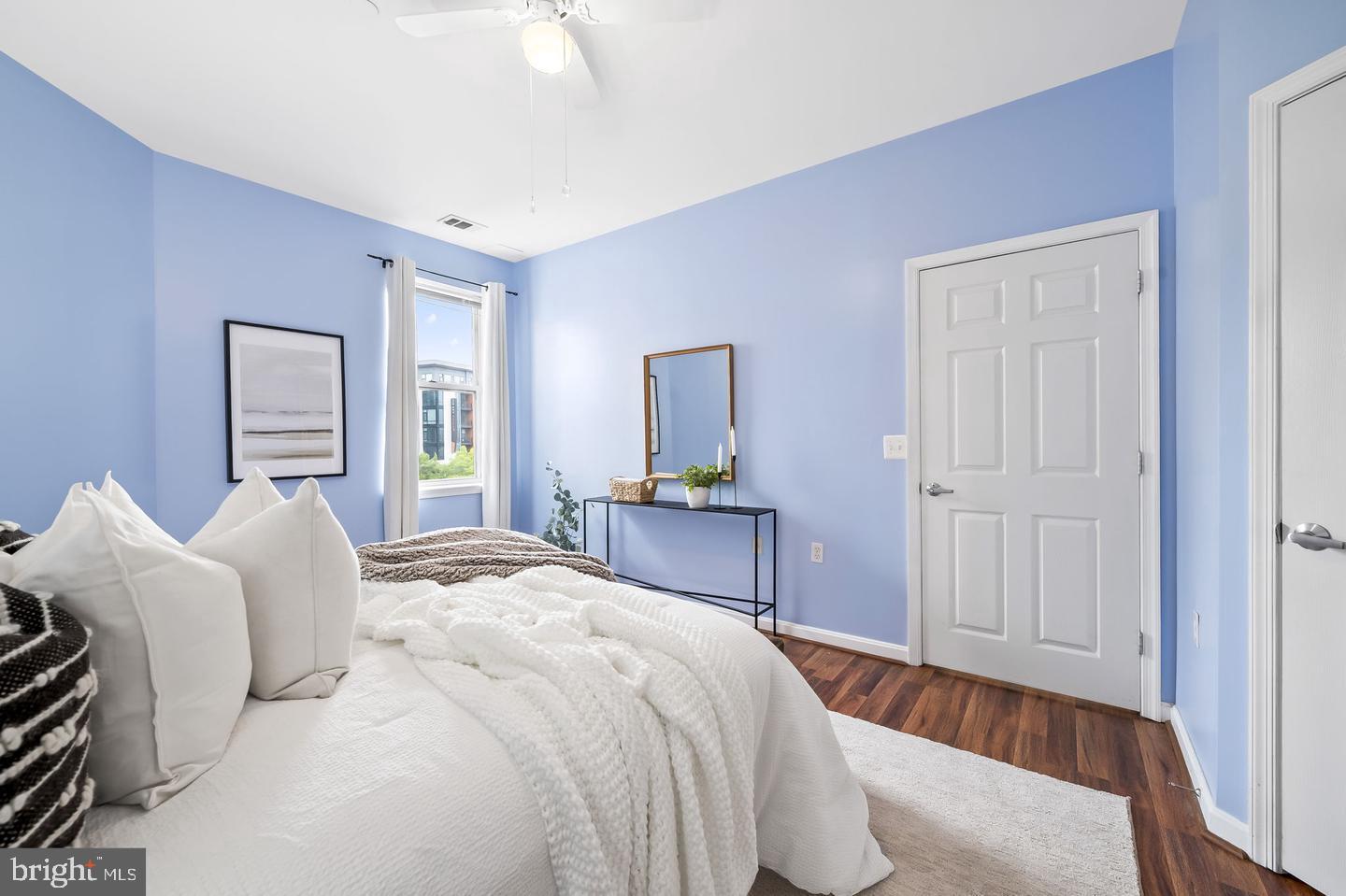 23 Pierside Drive, Unit 413 Baltimore, MD 21230 - Photo 15 of 36 a bedroom with a bed and a mirror