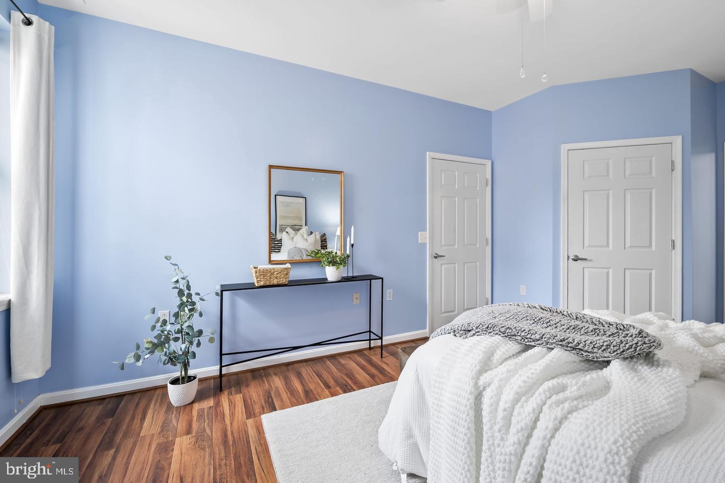 23 Pierside Drive, Unit 413 Baltimore, MD 21230 - Photo 16 of 36 a bedroom with a bed and wooden floor