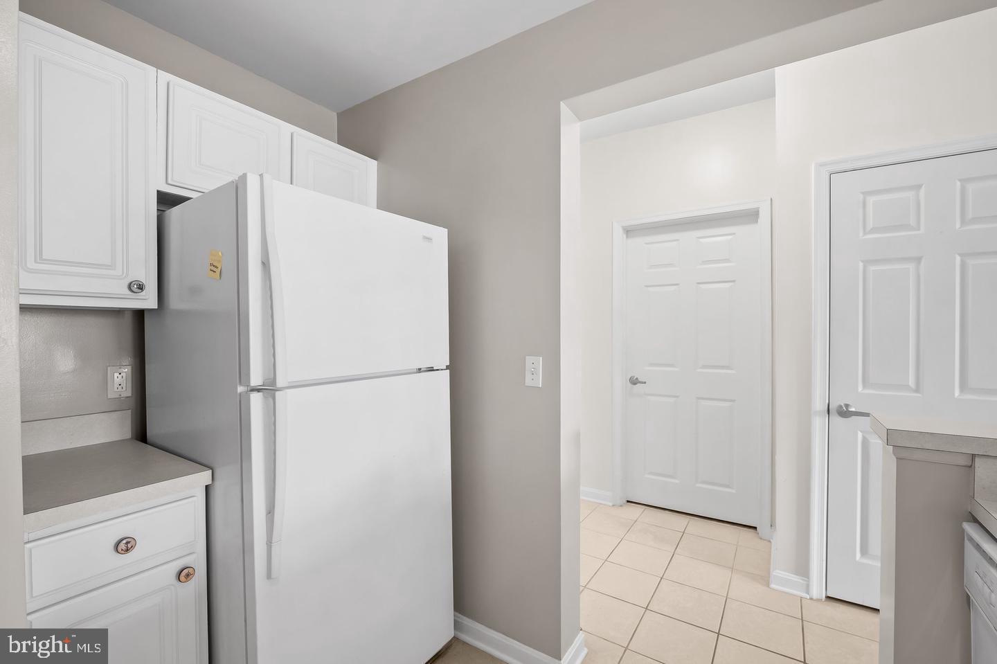 23 Pierside Drive, Unit 413 Baltimore, MD 21230 - Photo 6 of 36 a white refrigerator freezer and a stove sitting inside of a kitchen
