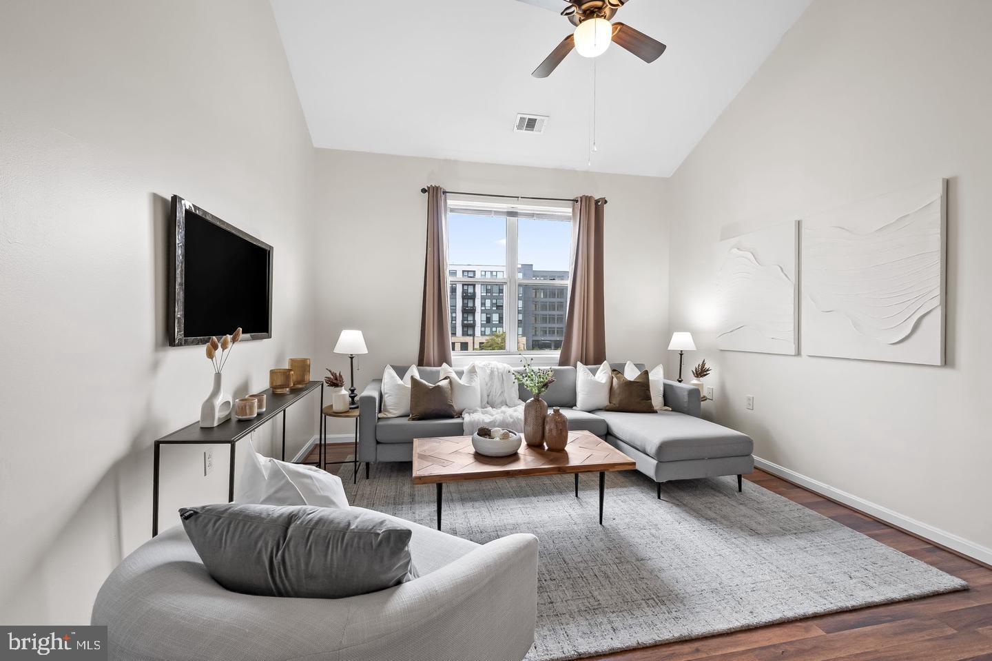 23 Pierside Drive, Unit 413 Baltimore, MD 21230 - Photo 10 of 36 a living room with furniture and a flat screen tv