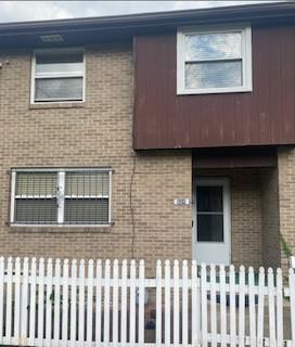 a front view of a house with a fence