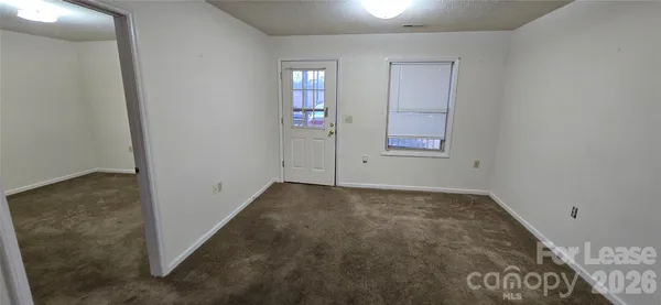 a kitchen with stainless steel appliances granite countertop a refrigerator a stove a sink and a window