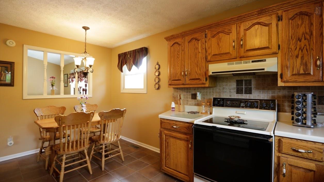 402 Ranch Road Portland, TN 37148 - Photo 11 of 24 a kitchen with a table chairs stove and microwave