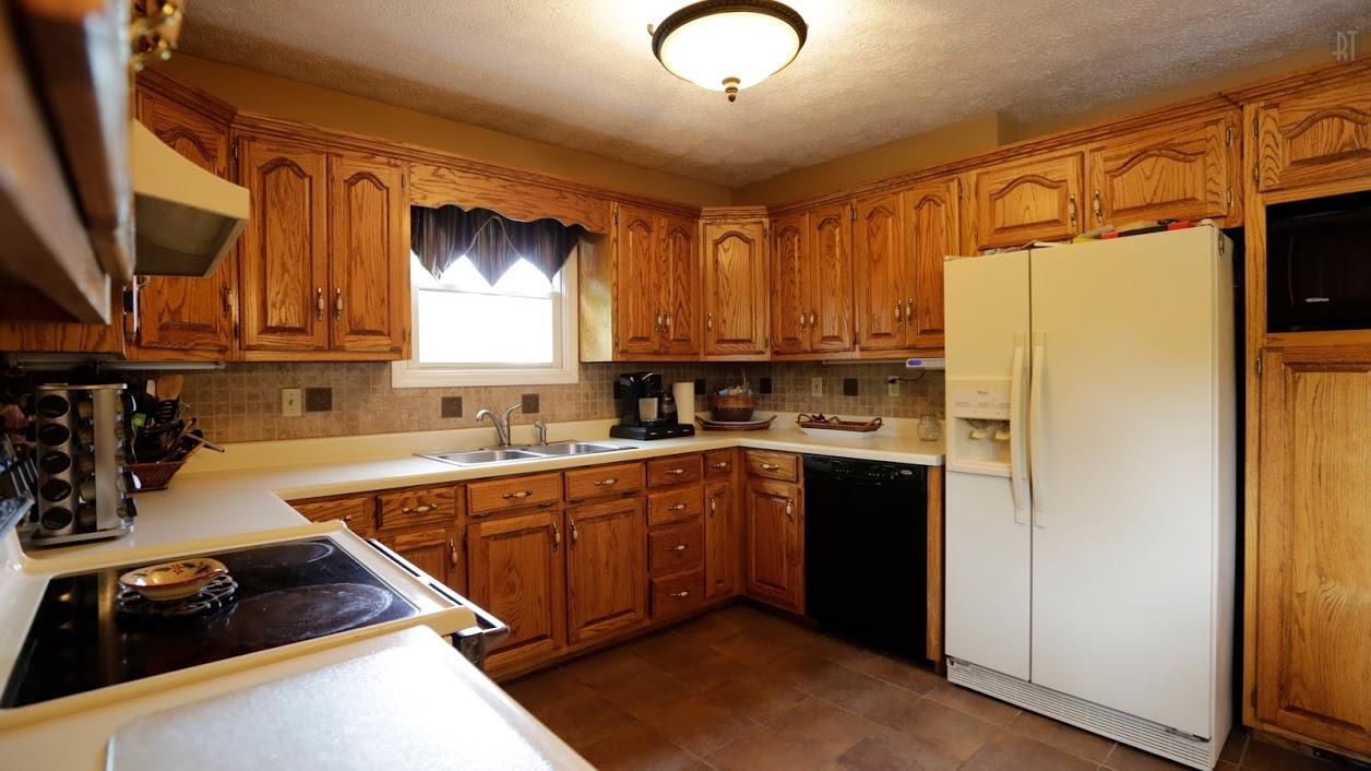 402 Ranch Road Portland, TN 37148 - Photo 12 of 24 a kitchen with stainless steel appliances granite countertop a refrigerator and a stove top oven