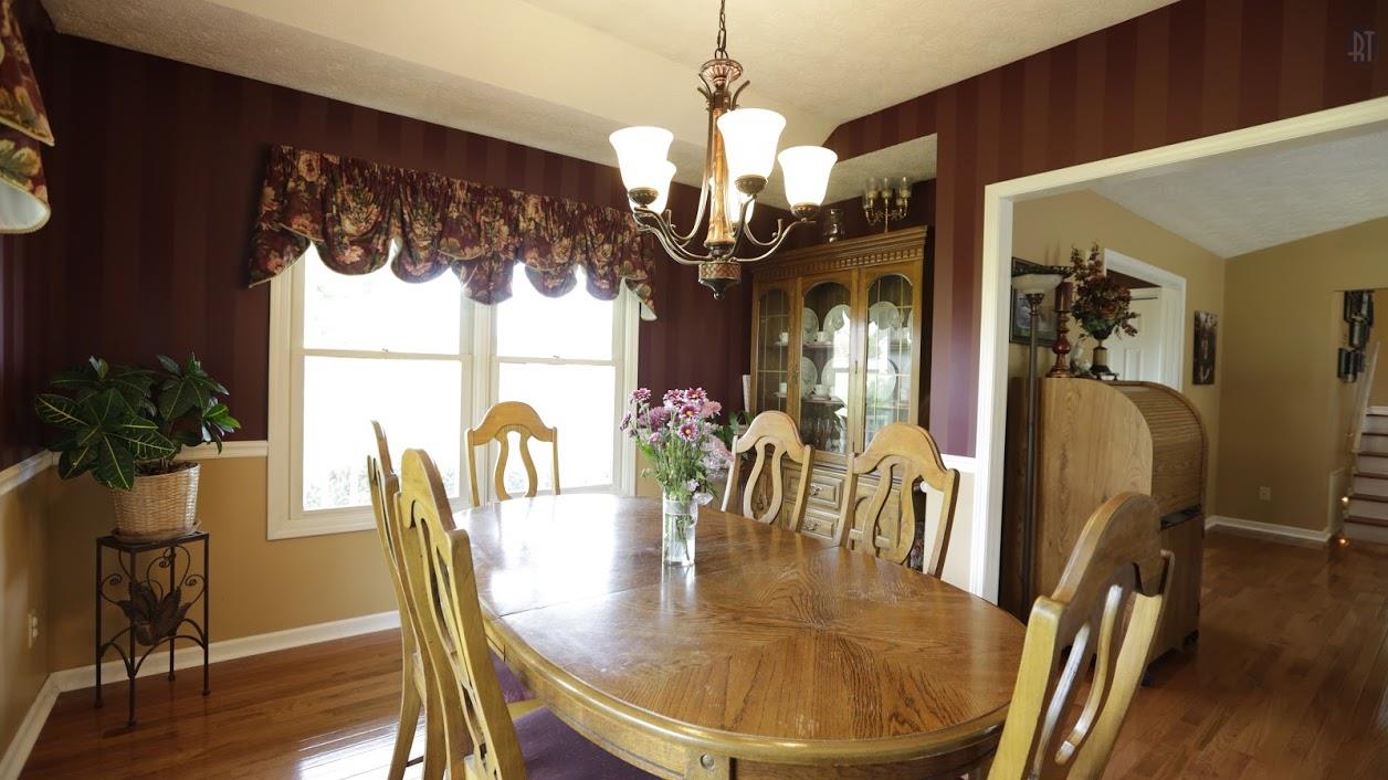 402 Ranch Road Portland, TN 37148 - Photo 14 of 24 a dining room with chandelier and wooden floor
