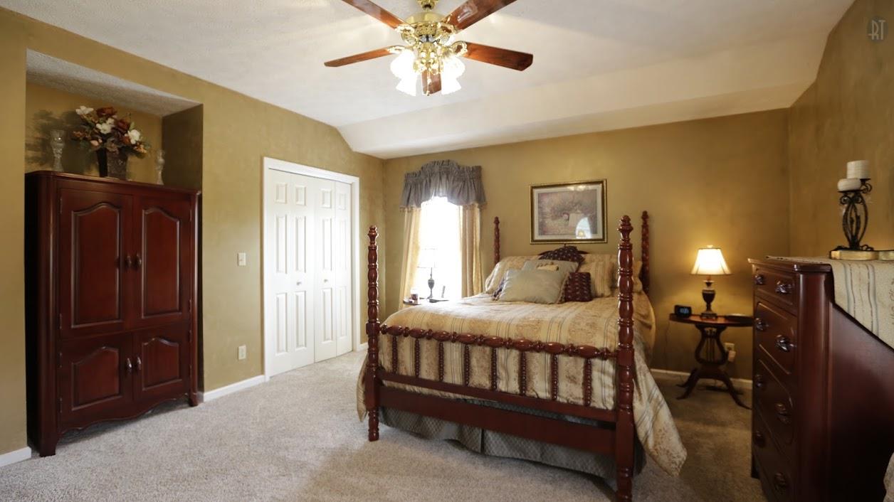 402 Ranch Road Portland, TN 37148 - Photo 17 of 24 a bedroom with a bed and a chandelier