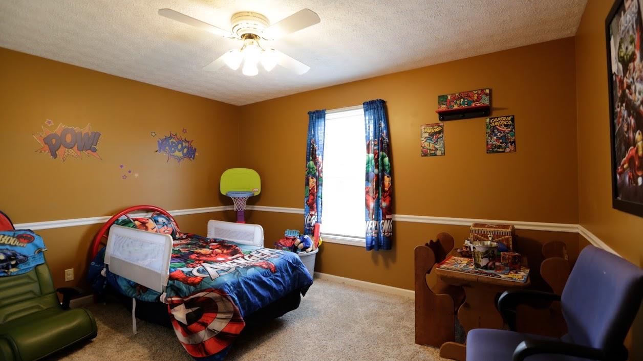 402 Ranch Road Portland, TN 37148 - Photo 21 of 24 a bedroom with a bed and a chandelier