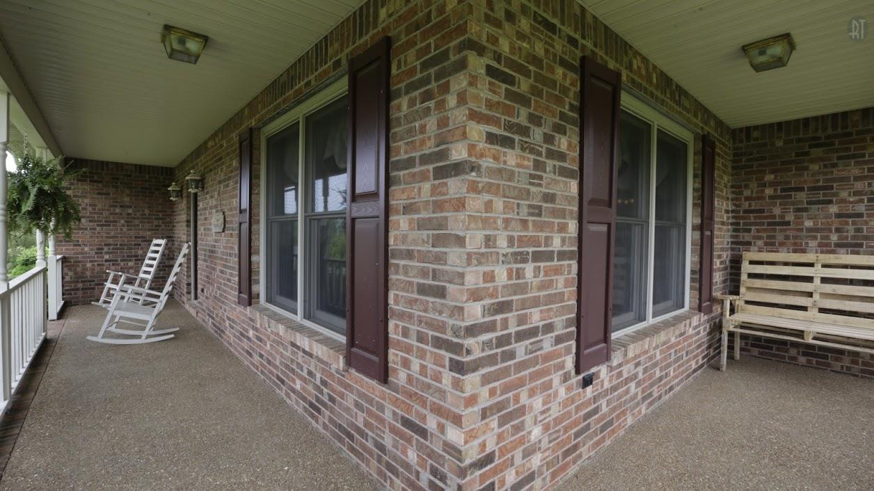 402 Ranch Road Portland, TN 37148 - Photo 5 of 24 a view of a porch with a table and chairs and potted plants