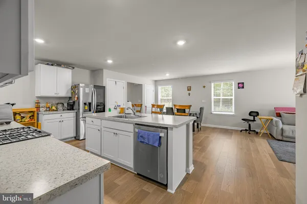 a kitchen with sink refrigerator and cabinets