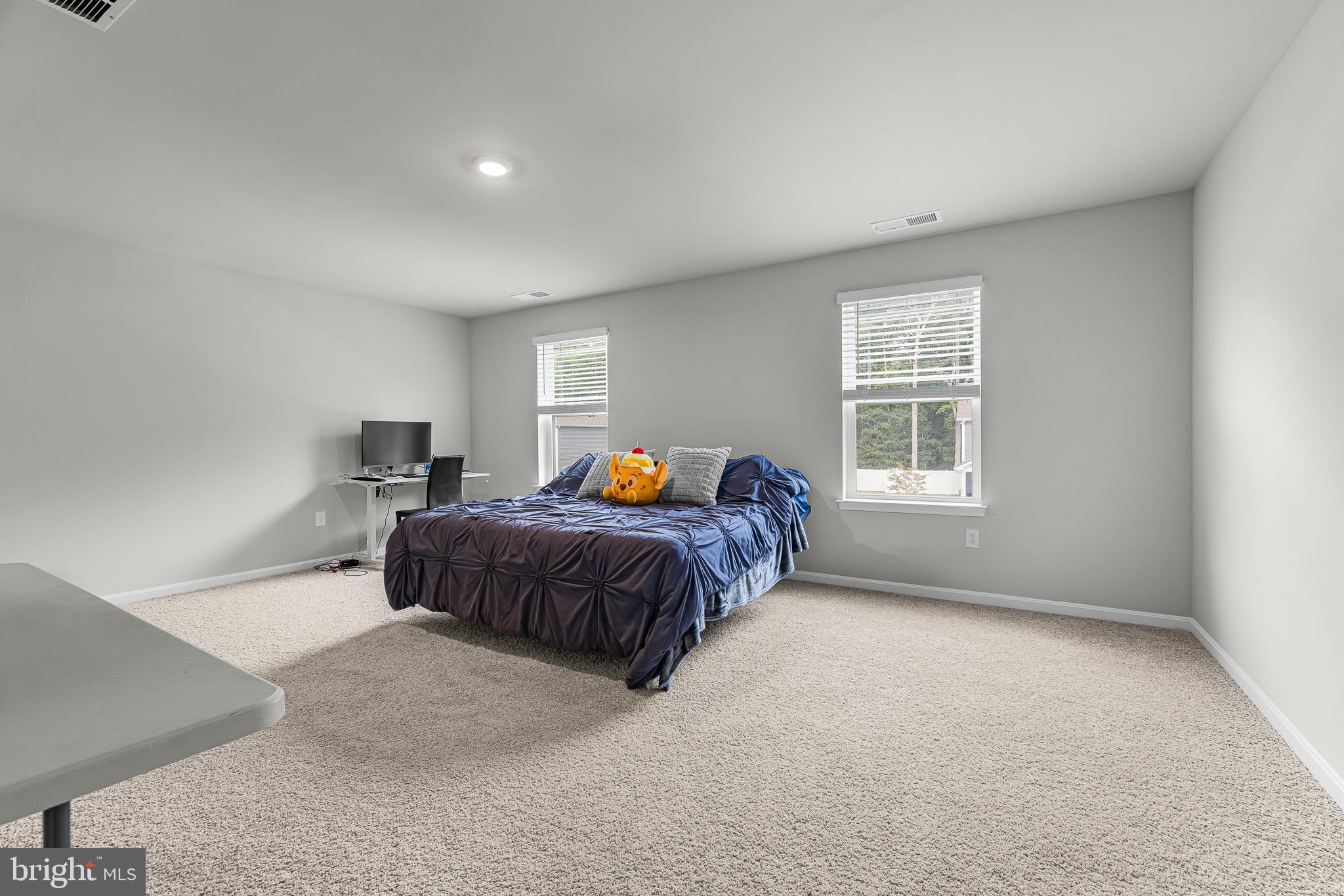 459 Currant Circle Magnolia, DE 19962 - Photo 15 of 39 a spacious bedroom with a bed and a window