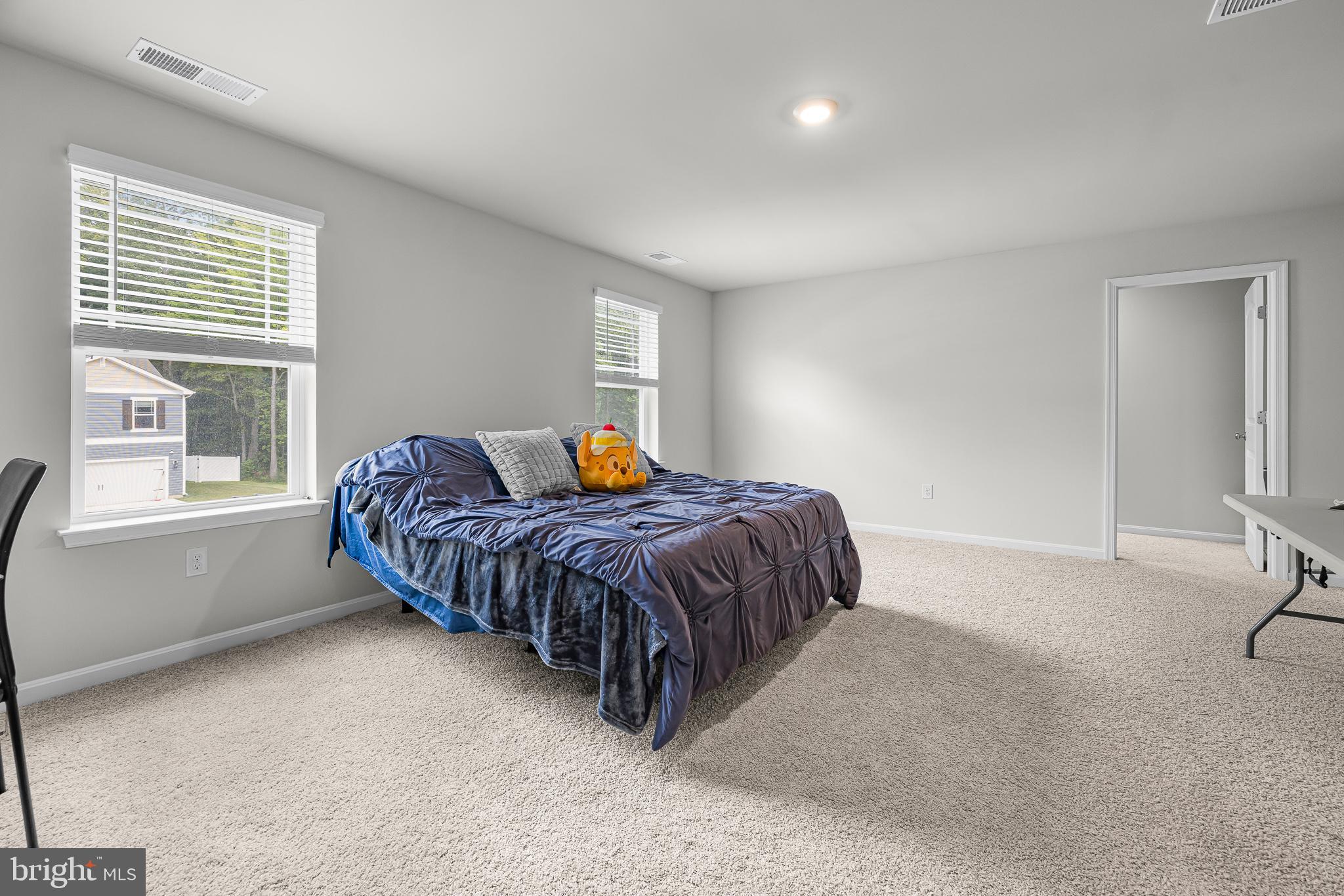 459 Currant Circle Magnolia, DE 19962 - Photo 17 of 39 a spacious bedroom with a bed and window