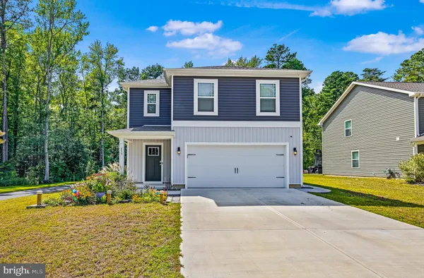 a view of a house with a swimming pool and a yard