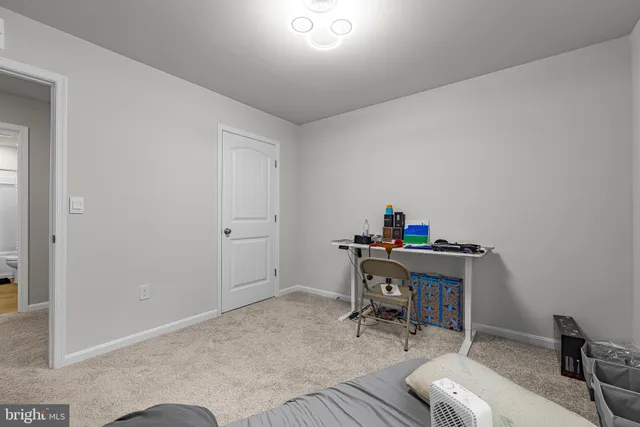 a view of a workspace with furniture and wooden floor