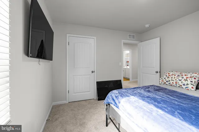 a bedroom with a bed and a television