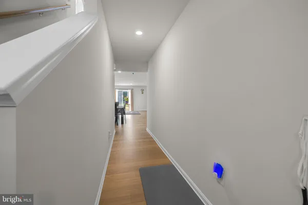 a hallway with wooden floor and entryway