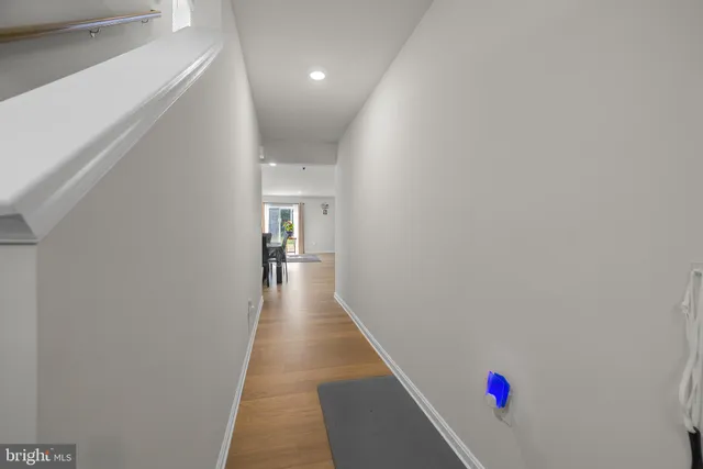a hallway with wooden floor and entryway