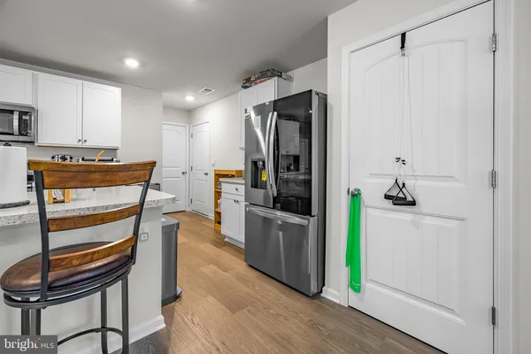 a kitchen with stainless steel appliances kitchen island granite countertop a refrigerator and a stove top oven