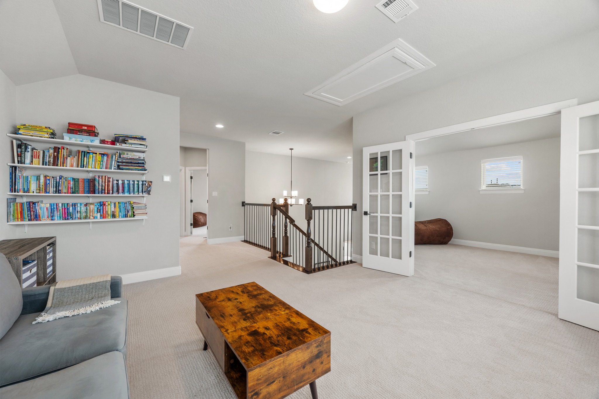 510 Elworth Path Austin, TX 78738 - Photo 19 of 40 a living room with furniture and a book shelf
