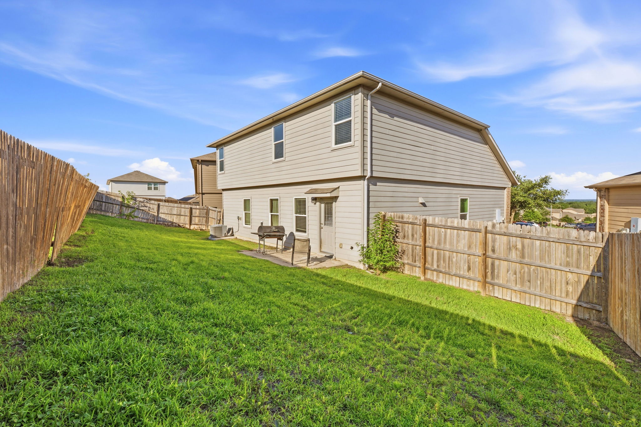 15101 Shell Bark Cove Austin, TX 78724 - Photo 25 of 26 Expansive sloped lawn area with a wood privacy fence