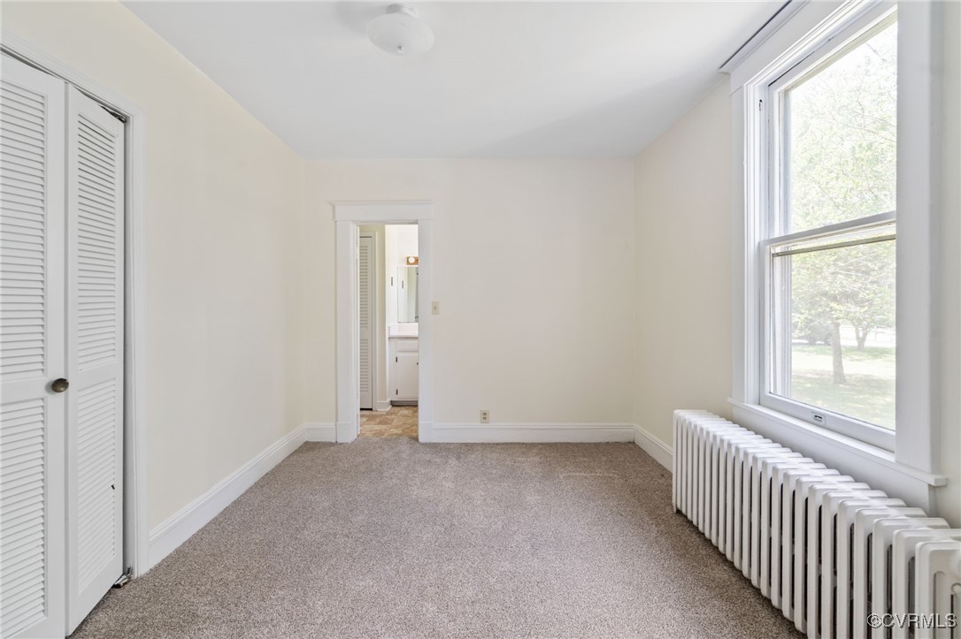 2707 Sherbourne Road Richmond, VA 23237 - Photo 11 of 50 Bedroom with radiator, light colored carpet, baseb