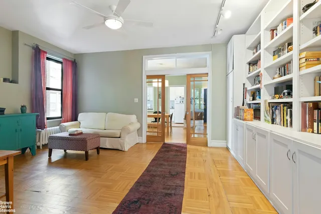 front view of a brick house with potted plants