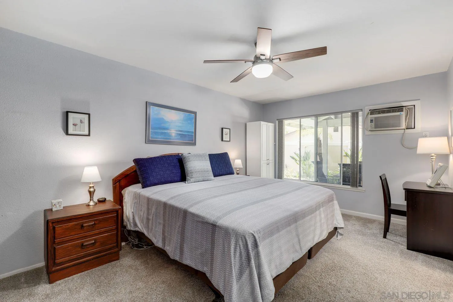 8531 Menkar Road San Diego, CA 92126 - Photo 13 of 37 a bedroom with a bed a chandelier and dresser