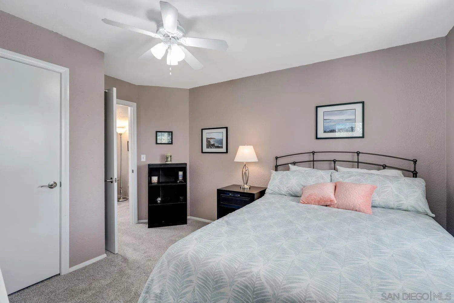 8531 Menkar Road San Diego, CA 92126 - Photo 20 of 37 a bedroom with a large bed and a chandelier