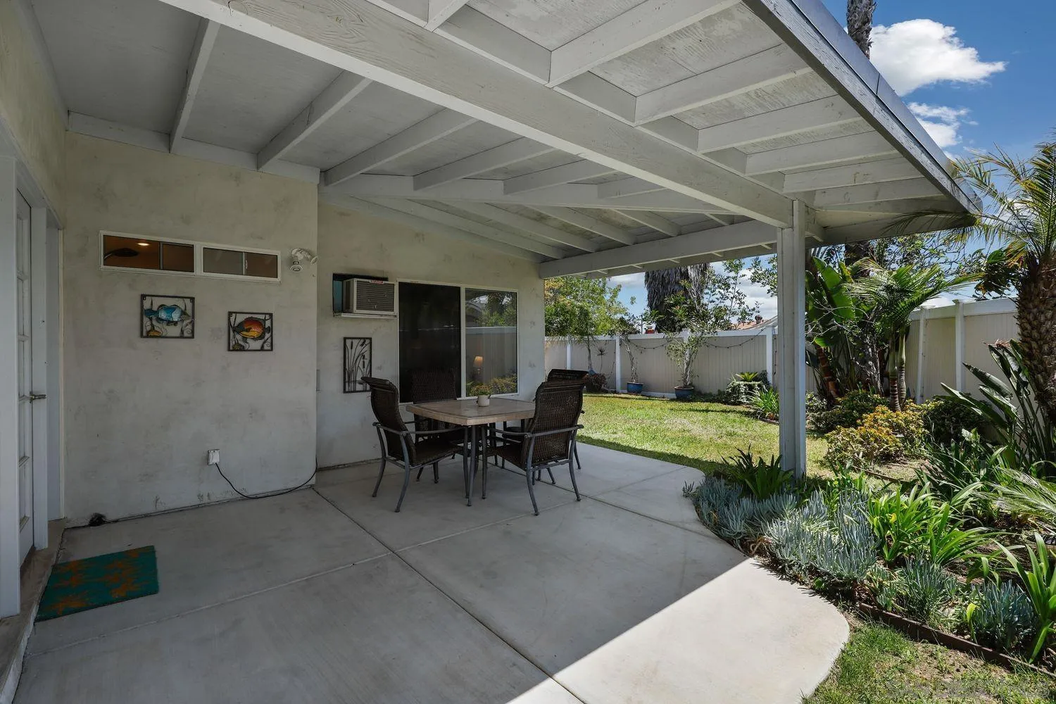 8531 Menkar Road San Diego, CA 92126 - Photo 30 of 37 a view of a patio with table and chairs potted plants with floor to ceiling window and potted plants