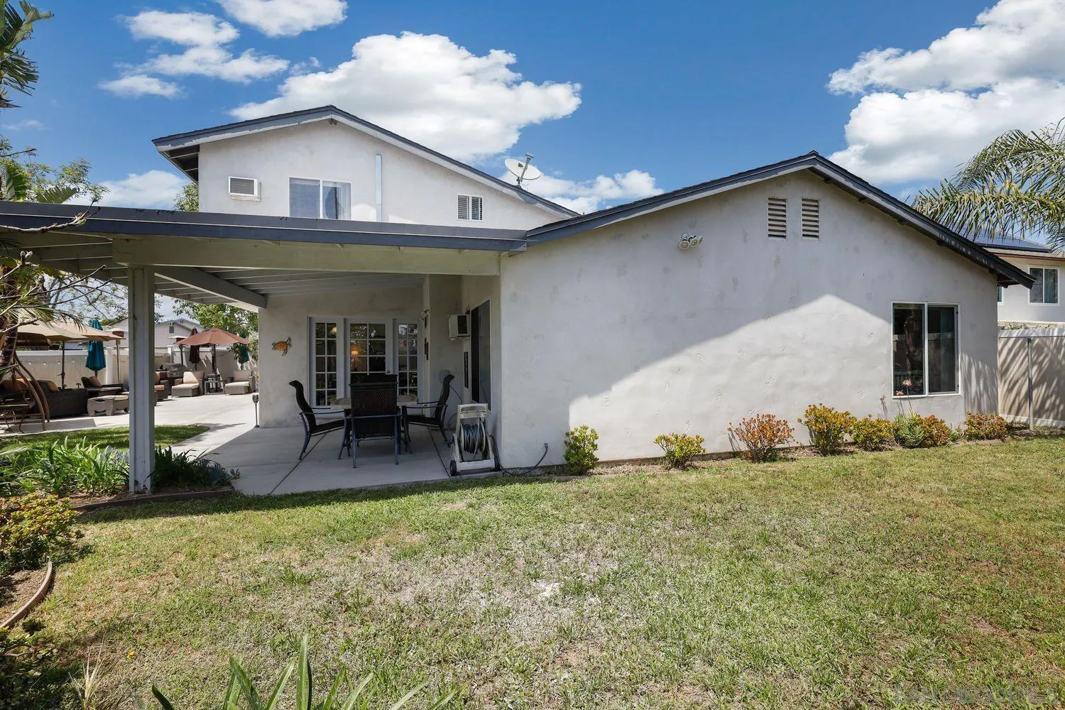 8531 Menkar Road San Diego, CA 92126 - Photo 33 of 37 a backyard of a house with table and chairs