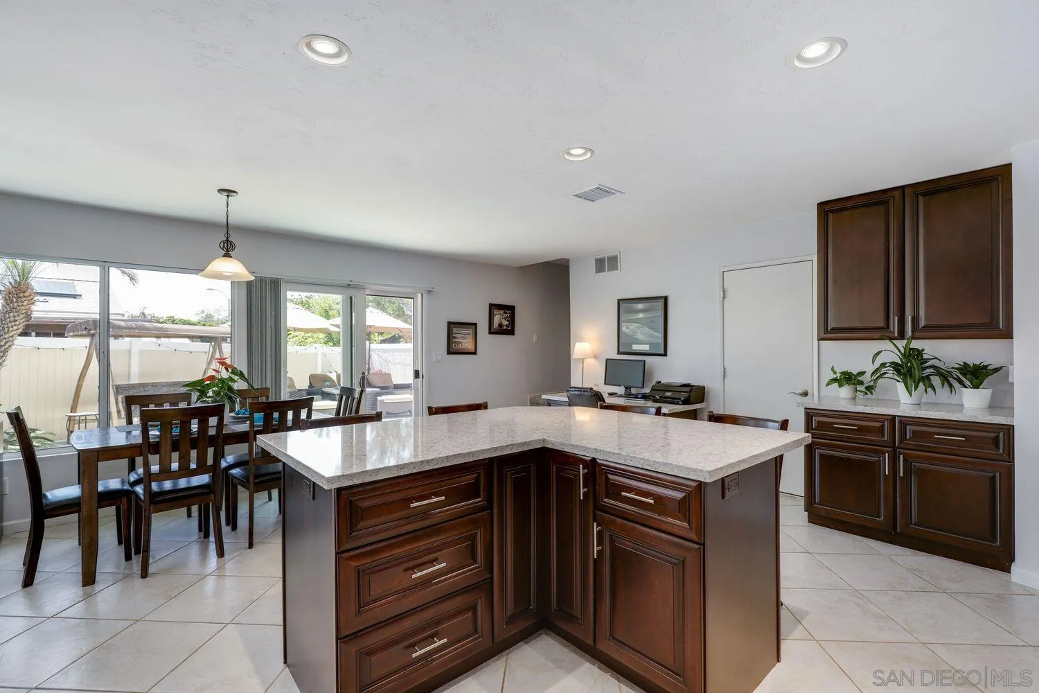 8531 Menkar Road San Diego, CA 92126 - Photo 9 of 37 a kitchen with a stove and a wooden cabinets