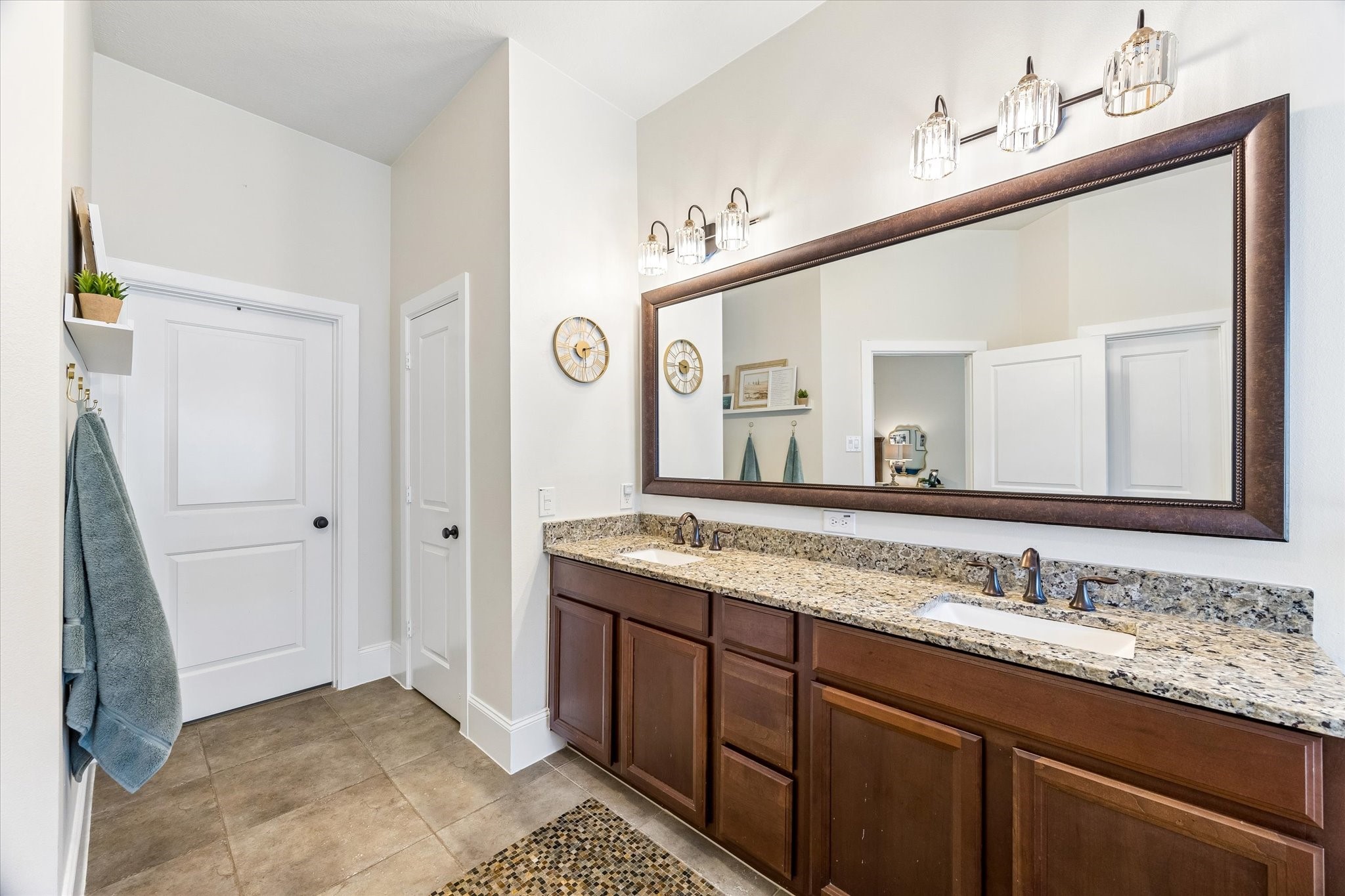 31306 Brighton Brook Lane Spring, TX 77386 - Photo 20 of 34 Luxurious owner's bath with a large framed mirror, extensive vanity storage, and elegant finishes throughout.